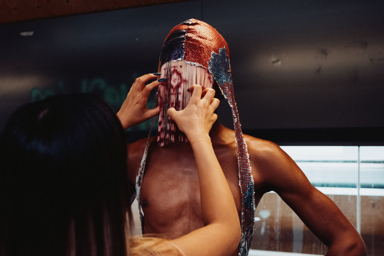 Backstage editorial portrait, sequinned veil over the face