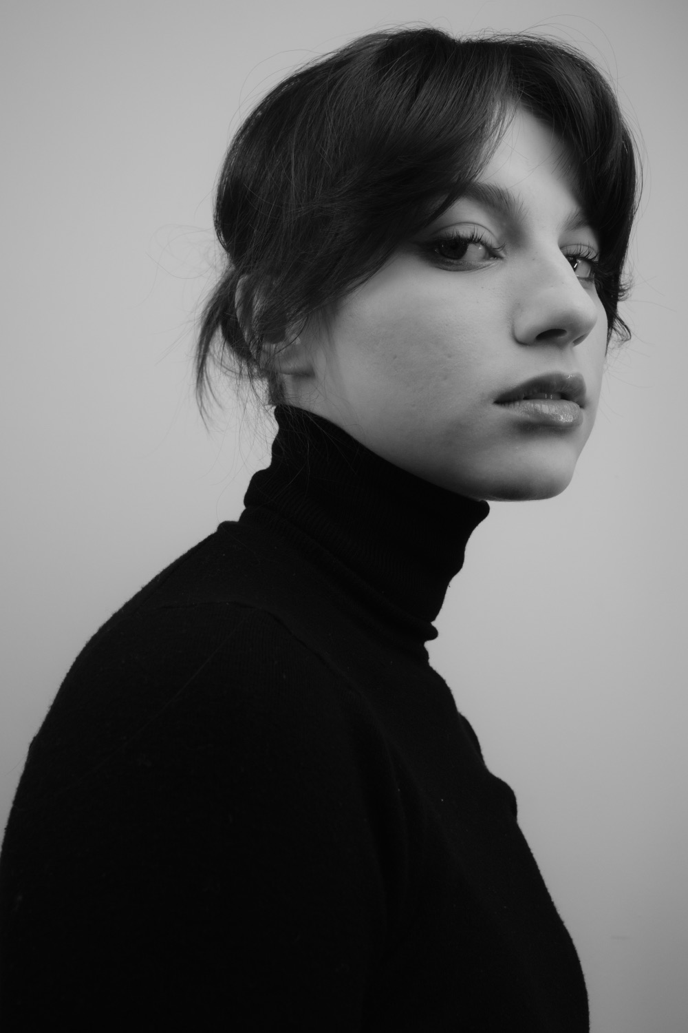 Black and white actor headshot of Emma in a dark turtleneck