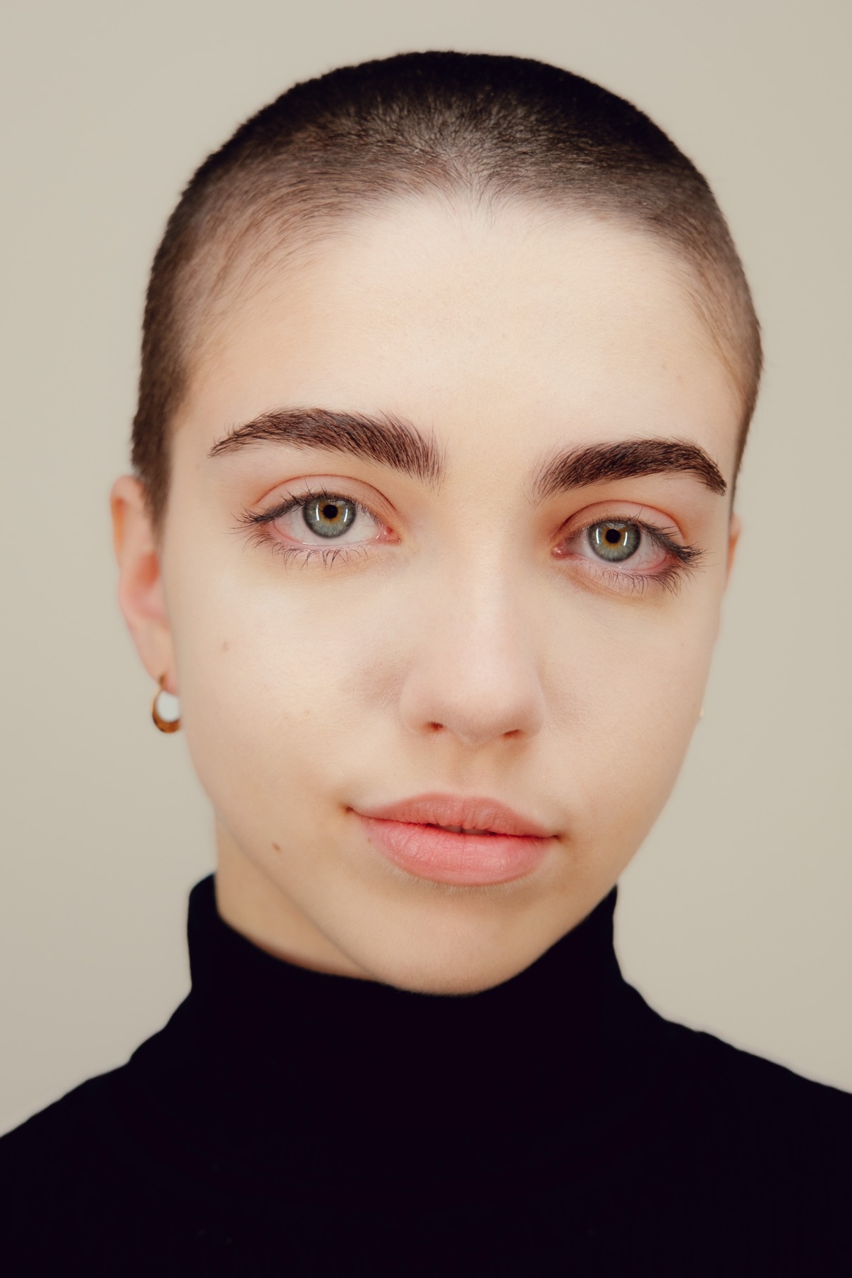 Close studio portrait of Victoria looking directly at the camera